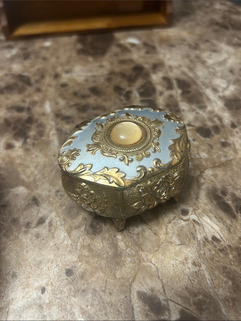 A vintage Japanese enameled metal trinket box with floral motifs